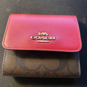 Women's COACH trifold wallet - burgundy accent on brown "C" signature